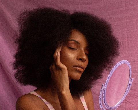 Close-up of a woman with soft, defined 4C curls showcasing natural hair care results.