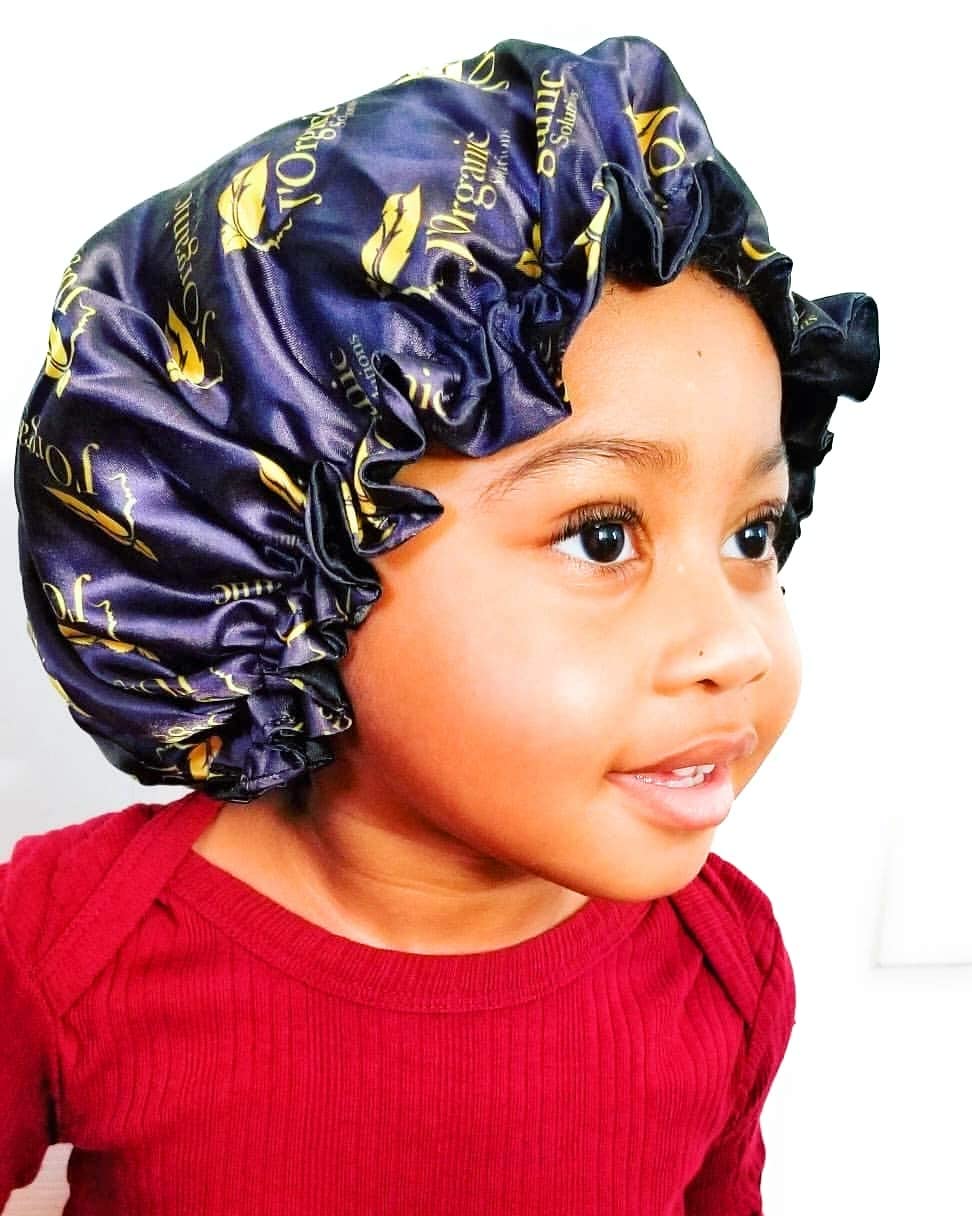 'Organic Solutions High-Quality Reversible Satin Bonnet in black and deep purple, designed for protecting hair and maintaining hairstyles, suitable for kids and adults."