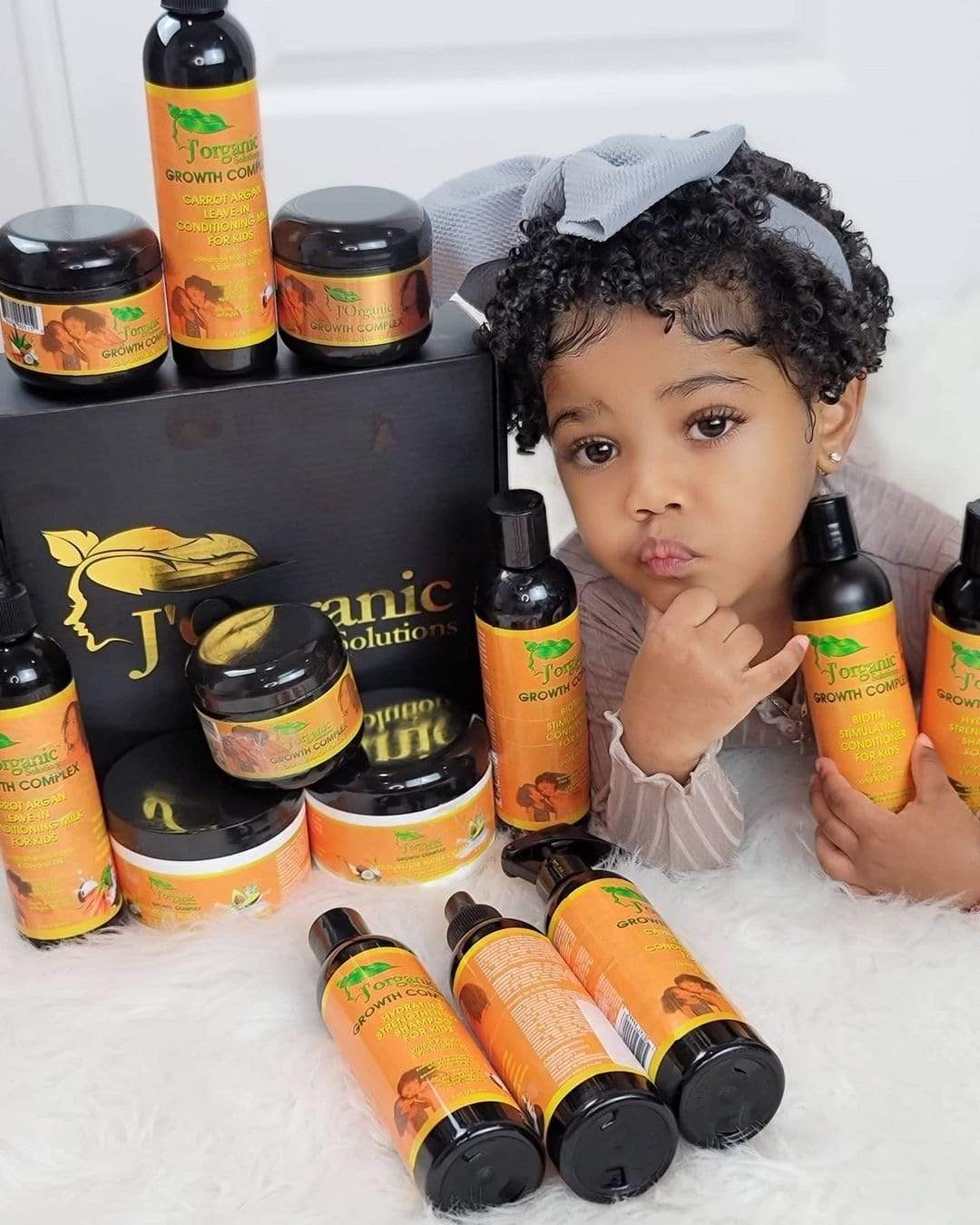 Kids includes a hydrating strengthening shampoo, biotin hair growth conditioner, moisture butter cream, and scalp stimulator designed for nourishing children's natural hair.